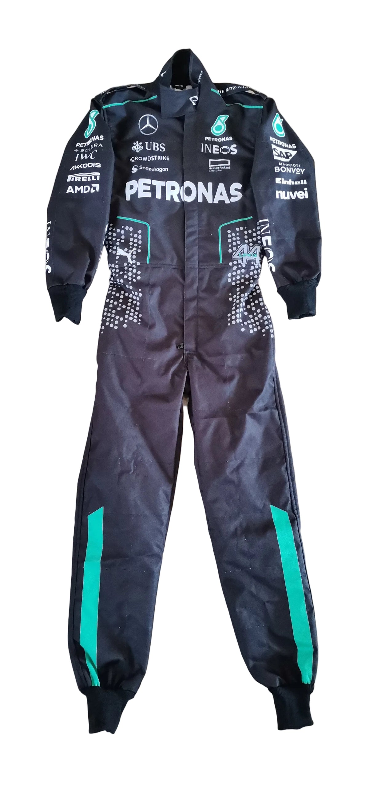A black Mercedes Petronas racing suit laid flat on a beige tiled floor, featuring green side stripes and various sponsor logos.