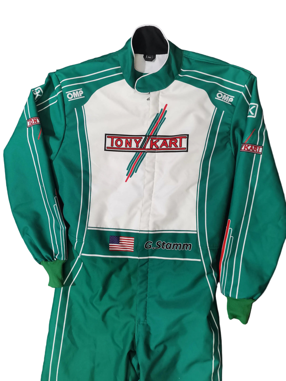 A green and white Tony Karl / G. Stamm racing suit laid flat on a black background.